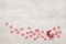 Small textile hearts and flowers on cement surface with copy space. Romantic background