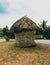 Small thatched roof hut built using natural materials like paddy straw or other natural things