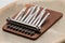 Small thumb piano with silver tines, brown wood