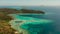 Small torpic island with a white sandy beach, top view.