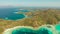 Small torpic island with a white sandy beach, top view.