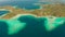 Small torpic island with a white sandy beach, top view.