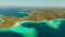 Small torpic island with a white sandy beach, top view.