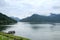 Small Tourist Boat in the Big Lake and Beautiful Mountain Scence