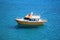 Small tourist boat at Preveli lagoon in crystal clear waters of Mediterranean sea in Crete. Greece.