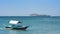 A small tourist outrigger boat is moored near Calayo Beach, while Loren island is visible in the background.