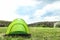 Small tourist tent in wilderness. Camping equipment