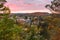 Small town in a hilly forested landscape at dusk in autumn