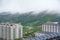 Small town mountain village in foggy with view of mountains and resort lodge apartment condo architecture building