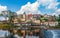 Small town panorama view with historic buildings and water weir