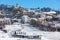 Small town on snowy hill in Piedmont, Italy.