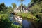 A small town with traditional old wooden houses, with a Dutch family enjoying the canal by boat