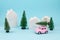 Small toy car carring christmas tree over the roof. Sesonal holidays, greeting card