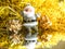 Small toy Santa Claus with gifts on a brilliant bright gold background.