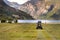 Small tractor with round baler haymaking on a field in Geiranger, Norway