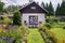 Small traditional cottage cabin with flower garden bed