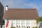 Small traditional gable house with USA flag at the front in La Jolla, California