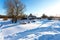 Small traditional Russian village in snowy frosty winter morning