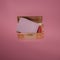Small treasure chest with classic ornaments in gold,  red velvet and letter in it, on  pink background. Flat lay concept