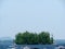 Small tree-covered island in Maine on a foggy day surrounded by boats