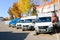 Small trucks, vans, courier minibuses stand in a row ready for delivery of goods on the terms. Belarus, Minsk, August 13, 2018