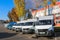 Small trucks, vans, courier minibuses stand in a row ready for delivery of goods on the terms of DAP, DDP