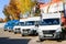 Small trucks, vans, courier minibuses stand in a row ready for delivery Incoterms 2010. Belarus, Minsk, August 13, 2018