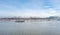 Small tugboat or towboat sail on the Danube river with clear blue sky above.