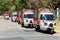 Small TukTuk Grocery Store Home Delivery Vehicles driving through suburbia