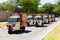 Small TukTuk Grocery Store Home Delivery Vehicles driving through suburbia