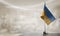 A small Ukraine flag on an abstract blurry background