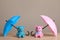 Small umbrellas and toy bears on wooden table