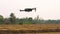 Small unmanned aircraft vehicle take off from the dry harvested paddy field.