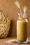 Small vermicelli in a glass jar on a wooden stand, scattered on the table