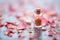 a small vial of rose essence on a bed of rose petals