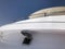 A small viewing window on a white large cruise yacht, a ship, a boat, a cruise liner against a blue sky