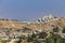 Small village and the Israeli West Bank barrier or wall - separation barrier on the West Bank in Israel. View from Montefiore