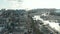 Small village in Malta revealing behind two Church Bell towers with boats in port on Sunny day, Aerial View