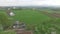 Small village outside city. Pets graze in meadow, aerial view