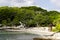 Small virgin cove hidden among big green trees