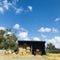 Small warehouse with tractors and straw.