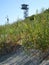 A small watchtower over a sunlit beach of Baltic Sea in Piaski