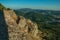 Small watchtower and stone wall over cliff with mountainous landscape