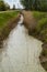 A small water channel leading to the dam