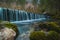 Small water dam at the river spring of Kamniska Bistrica in Slovenia in dry winter time. Cold enchanted waterfall with flowing