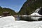 Small water dam with two wooden houses near by tourist path heading directly towards to Murg lakes