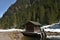 Small water dam with wooden house near by tourist path heading directly towards to Murg lakes