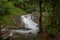 Small waterfall with cryatal clear water stream near the campground on the way to Pitugro WaterfallPetro Lo Su in Umphang Wildli