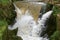 Small waterfall fast-flowing in between rocks, at Sakarya river in Bilecik.