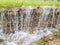 A small waterfall. Flowing water erodes the soil